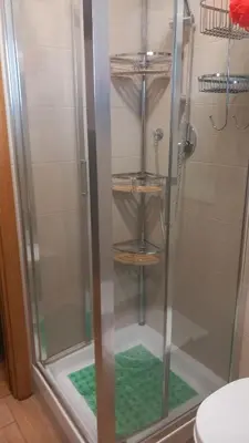a shower with a glass door in a bathroom at Bilocale EUR Grotta Perfetta 50mq casa 32mq sala hobbies e 250mq giardino in Rome
