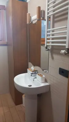 a bathroom with a white sink and a mirror at Bilocale EUR Grotta Perfetta 50mq casa 32mq sala hobbies e 250mq giardino in Rome