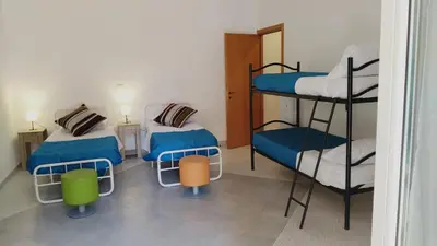 a room with two bunk beds and two chairs at Trionfale Guest House in Rome