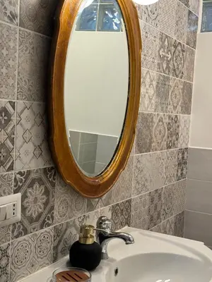 a bathroom with a sink and a mirror at NOI Luxury rooms Colosseum in Rome