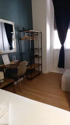 a living room with a shelf and a table and a chair at NOI Luxury rooms Colosseum in Rome