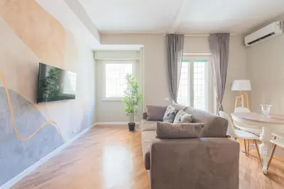 a living room with a couch and a table at SuityRHome San Giovanni 11 in Rome