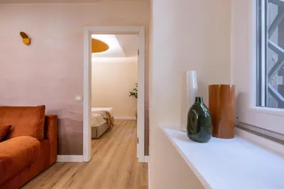 a living room with a couch and a window at Colosseum Essence - Homkeey Apartments in Rome
