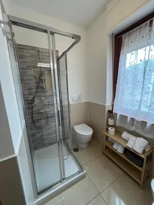 a bathroom with a shower and a toilet at Trilocale con terrazza e garage in Rome