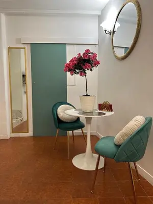 a table with two chairs and a vase with flowers on it at incanto e campo de fiori in Rome