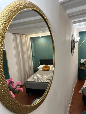 a mirror in a room with a bed and a bed at incanto e campo de fiori in Rome