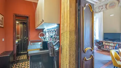 a kitchen with orange walls and a counter top at La Casa d'Argento in Rome