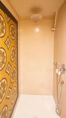 a bathroom with a shower with a wall at La Casa d'Argento in Rome