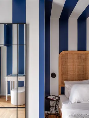 a bedroom with blue and white walls and a bed at Zen Trastevere Luxury Room - Zen 54 in Rome