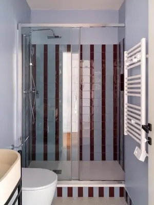 a bathroom with a shower with a toilet and a sink at Zen Trastevere Luxury Room - Zen 54 in Rome