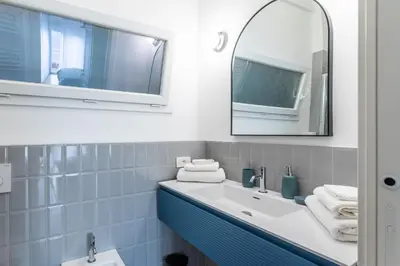 a bathroom with a white sink and a mirror at Domus Veneranda in Rome