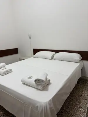 a white bed with towels on top of it at Roma Belvedere Termini in Rome