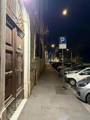 a street with cars parked on the side of a building at Roma Belvedere Termini in Rome