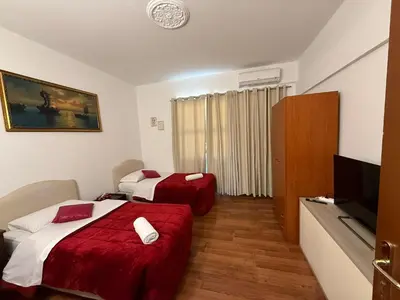 a hotel room with two beds and a flat screen tv at Two Ducks Hostel in Rome
