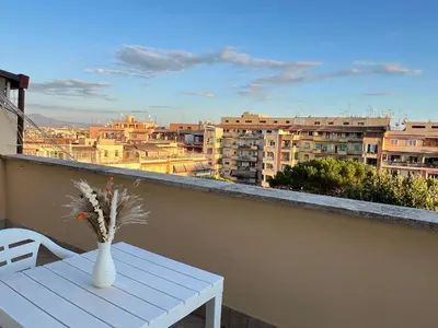 a vase of flowers on a table on a balcony at Oasi di pace in Rome