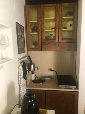 a kitchen with a counter with a sink and a cabinet at Trastevere Mini-apartment in Rome