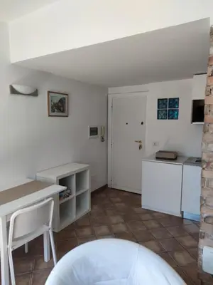 a kitchen with white counters and a table at Monti loft al Colosseo in Rome