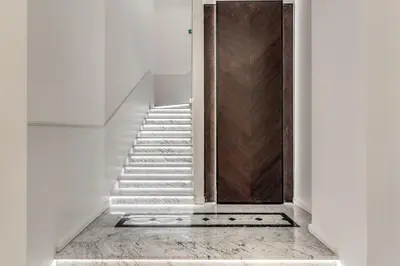 a hallway with a staircase with a brown door at The Spotlight Boutique Hotel in Rome