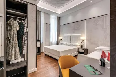 a hotel room with a bed and a desk at The Spotlight Boutique Hotel in Rome