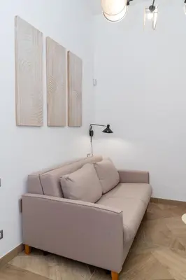 a couch in a living room with two pictures on the wall at Angelico living Rome in Rome
