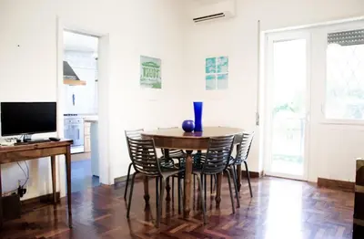 a dining room with a table and chairs at Dolcevita suite in Rome