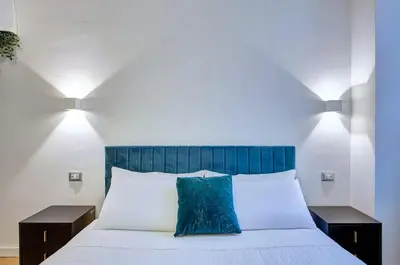 a pile of towels and a bucket on a bed at Cinema Design Home San Giovanni in Rome