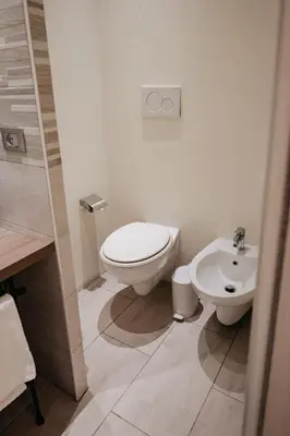 a bathroom with a toilet and a sink at Room 230 Roma Luxury Suites in Rome