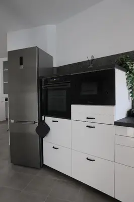 a kitchen with a microwave and a refrigerator at Sweet Home Fleming in Rome