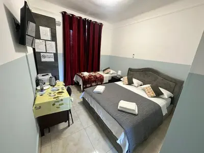 a bedroom with a bed and a table in it at TERMINI ROMA CENTRo in Rome
