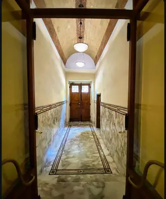 an open door leading to a hallway with a door at Residenza Merulana in Rome
