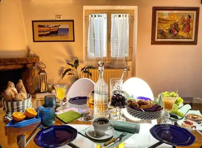 a table with plates of food on top of it at Residenza Merulana in Rome
