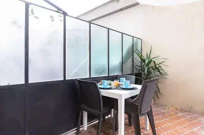 a table with chairs and cups on top of it at Imperium Garbatella Guesthouse - 2 bedrooms with private bathroom, Terrace, 800mt to metro in Rome
