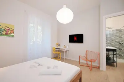 a white room with a bed and a table and chairs at Pop Domus Guest House o Affittacamere in Rome