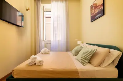 a bedroom with a bed with towels on it at Candia Retreat in Rome