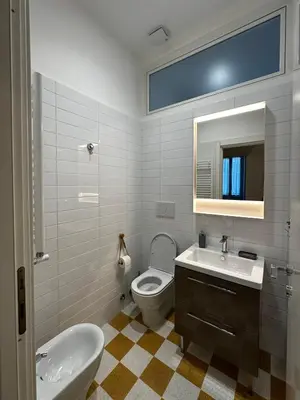 a bathroom with a sink and a toilet and a mirror at La Casabella Rome Center in Rome