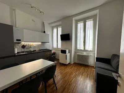 a kitchen and living room with a table and chairs at La Casabella Rome Center in Rome