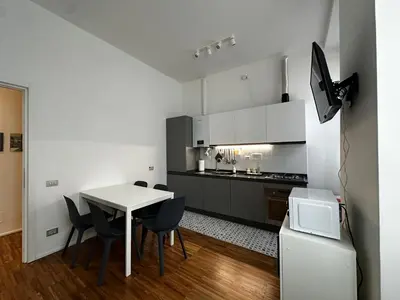 a small kitchen with a white table and chairs at La Casabella Rome Center in Rome