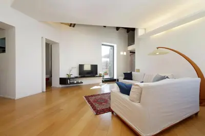 a living room with a white couch and a tv at YCH-Splendido attico con terrazzo a San Giovanni in Rome