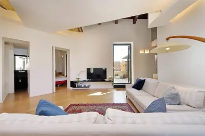 a living room with a white couch and a tv at YCH-Splendido attico con terrazzo a San Giovanni in Rome