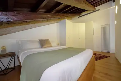 a bedroom with a large white bed in a room at YCH-Splendido attico con terrazzo a San Giovanni in Rome