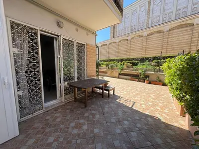 a patio with a wooden table and a bench at La Casa di Valentina in Rome