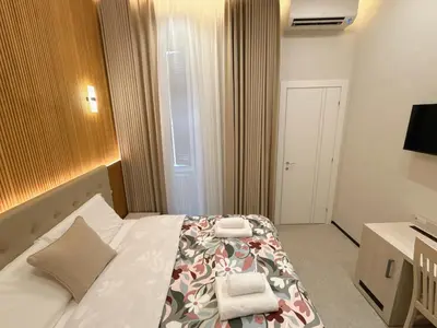 a hotel room with a bed with two towels on it at Luxe roma in Rome