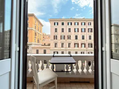 a view from a balcony with a table and a chair at Luxe roma in Rome