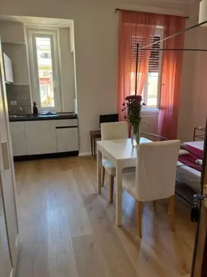a kitchen and dining room with a table and chairs at Mila house suite in Rome