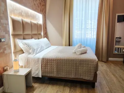 a bedroom with a bed with two white towels on it at Nicole Suite in Rome