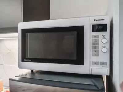 a microwave oven sitting on top of a shelf at Quiet, Cozy flat near citycenter in Rome