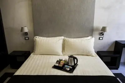 a hotel room with a bed with a tea kettle on it at Campo De’ Fiori Prestige Rooms in Rome