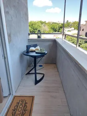 a small table on a balcony with a window at Hortus in Rome