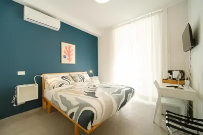 a bedroom with a bed with a blue wall at Domus Paruta in Rome