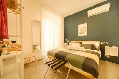 a bedroom with a bed and a chair in it at Domus Paruta in Rome